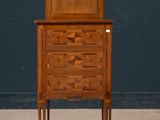 an image of a small wooden cabinet with drawers and a door