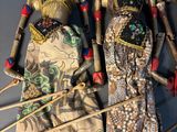 two dolls of asian women are standing next to each other on a table