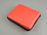 an orange and black case sitting on top of a table