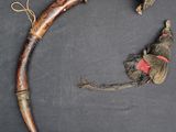 an old horn with a red ribbon on it