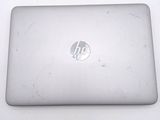 a white laptop with a hp logo on the screen