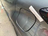 a sticker on the door of a car with a name tag attached to it