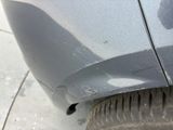 a close up of a car ' s front bumper with scratches on it