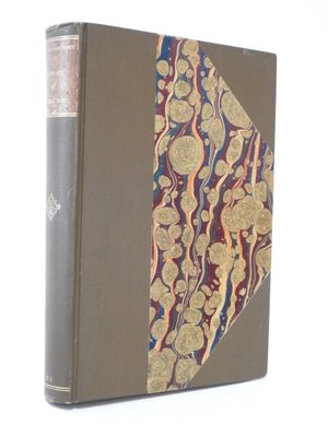 an old book with a gold and blue cover on a white background