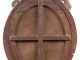 an image of a round wooden window with a cross in the center