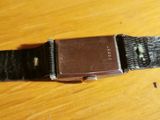 an image of a watch sitting on top of a wooden table