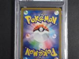 a close up of a pokemon card in a plastic case