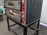 an image of a commercial pizza oven on a stand