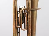 an image of a brass tuba on a stand against a white background