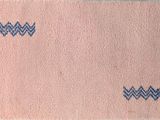 pink and blue rug with zigzag design on it