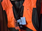 an orange vest with a tag on it hanging on a rack