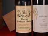 two bottles of wine sitting next to each other on a table