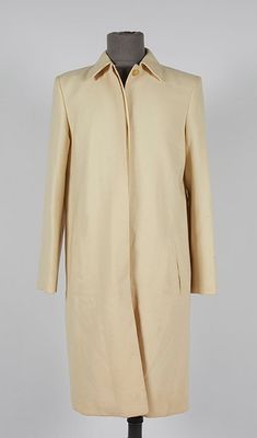 an image of a beige coat on a mannequin mannequin