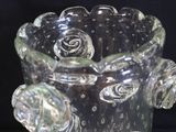 a glass vase that has a flower inside of it