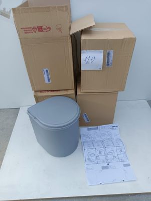 several boxes and a trash can sitting on top of a white table