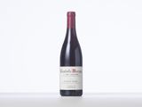 a bottle of red wine sitting on top of a table