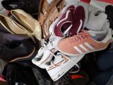 many pairs of shoes that are sitting in a basket