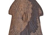 an old rusty object with a hole in the middle