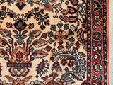 an antique persian rug with a floral design on a blue background
