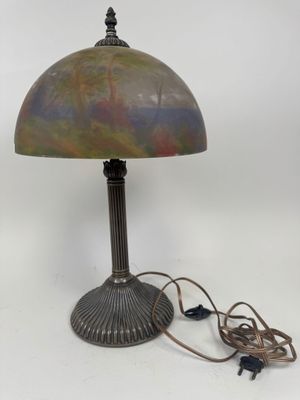 a lamp that is sitting on top of a table next to a cord