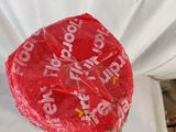 a red bag of gummy pops on a table