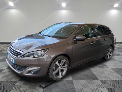 the grey car is parked on a checkered floor in a garage