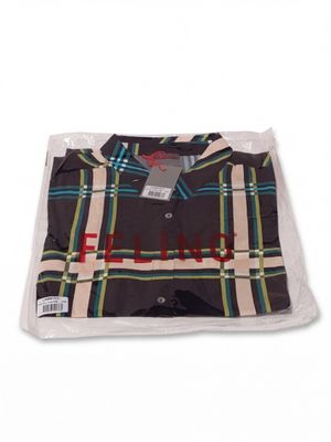 a shirt wrapped in a plastic bag on a white surface