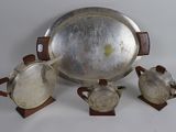 a silver tray with three silver cups and a silver tray with two silver cups on it