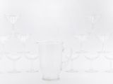 a lot of wine glasses and a pitcher on the table