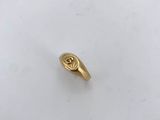 an image of a gold ring on a white surface