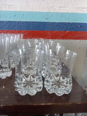 many glasses on a table with a blue and red stripe