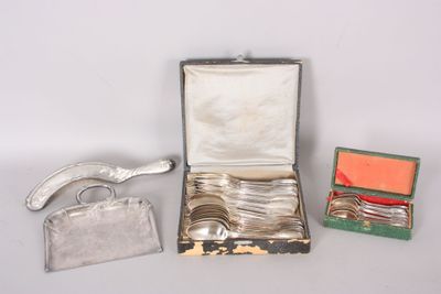a silver case with silverware in it on a table