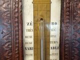 a wooden frame with a thermometer on it