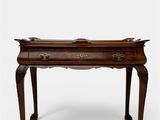 an old wooden table with a drawer on top of it