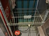 an image of a metal wire shelf in a room