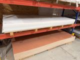 many shelves with mattresses on them in a warehouse