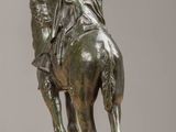 statue of a man on a horse with a spear on a table