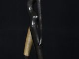 a bronze statue of a woman holding a vase on her head