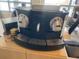 a coffee machine sitting on top of a wooden table