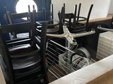 many chairs and a table in a room with a boat on the wall