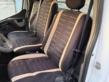two seats in the back of a van with a steering wheel