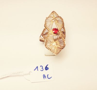an image of a gold ring with a red stone on it