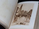 an open book with a picture of a horse drawn carriage in it