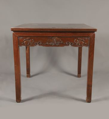 une petite table en bois avec un plateau en marbre sur fond gris