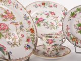 a group of plates and cups on a stand