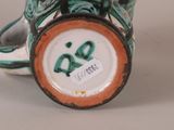 a close up of a vase with a bird on it