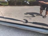 a reflection of a man in the side mirror of a car