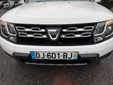 the front end of a white pick up truck parked in a parking lot