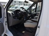 a white van with the door open and the driver ' s seat down