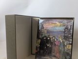 an open book with a picture of a group of people standing in front of it